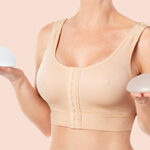 Woman wearing compressing bra after breast augmentation