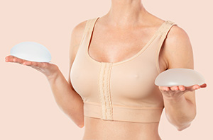 Woman wearing compressing bra after breast augmentation