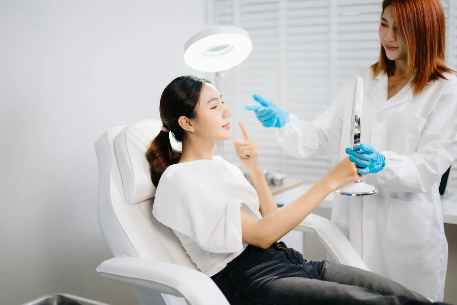Patient viewing her skin during a chemical peel consultation